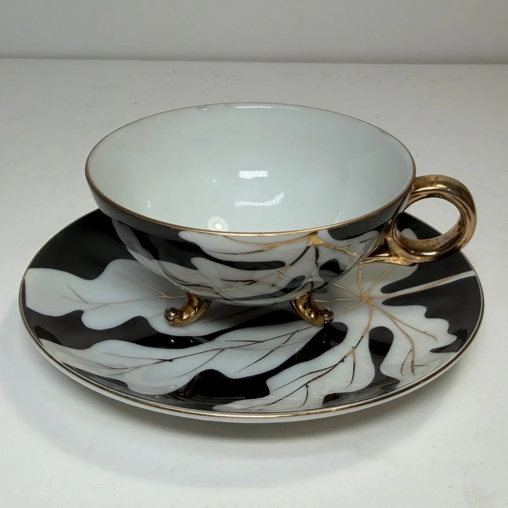 Footed Tea Cup and Saucer Black White Gold Leaf MCM Holywood Regency Art Deco